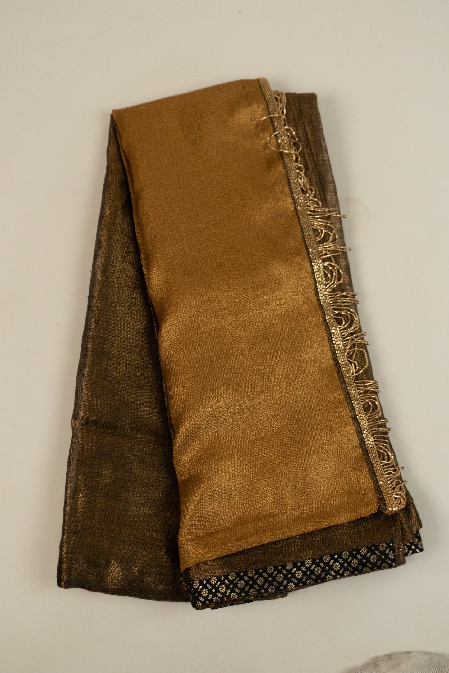 Metallic Gold Linen Saree with Brocade Facing and Decorative Hand-Embroidered Katdana Lace at the Pallu