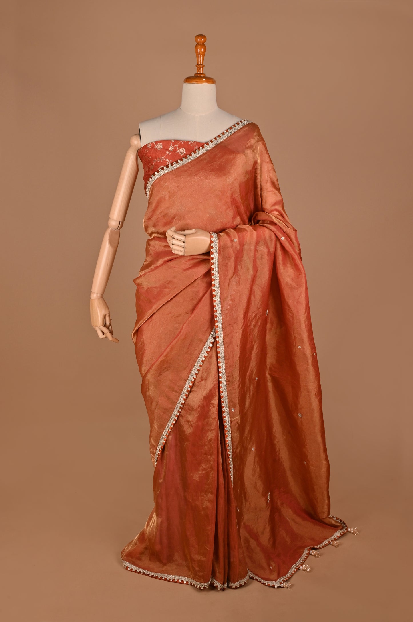 Earthy Rust Tissue Saree with Lace Border and Tassel Details