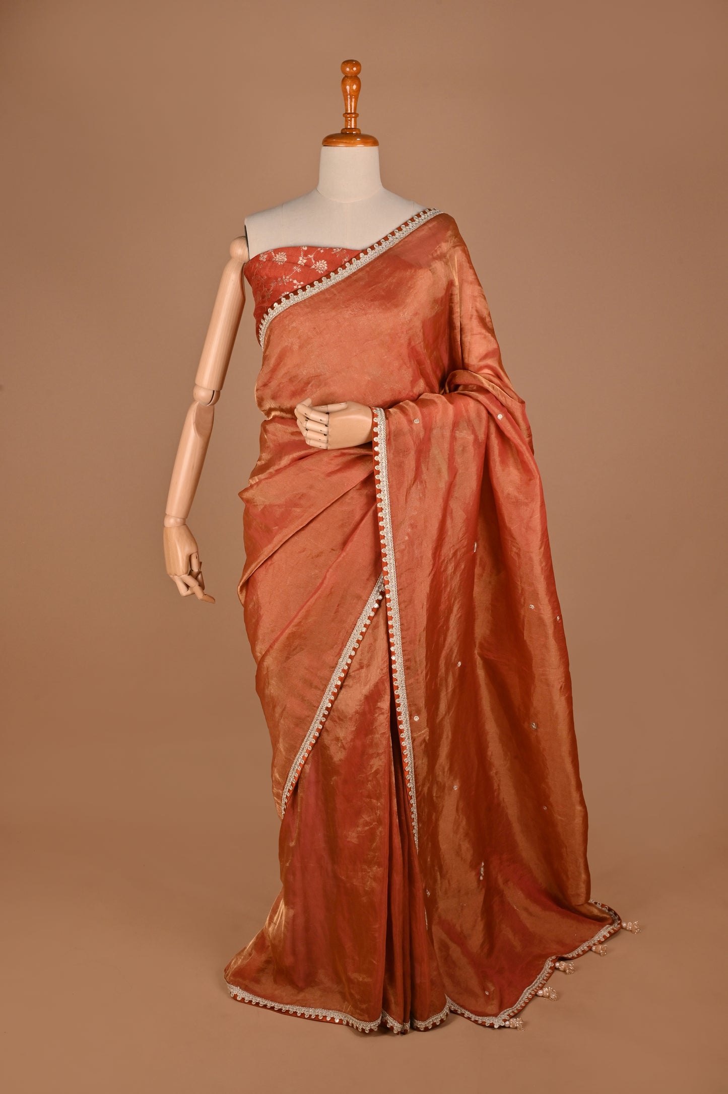 Earthy Rust Tissue Saree with Lace Border and Tassel Details