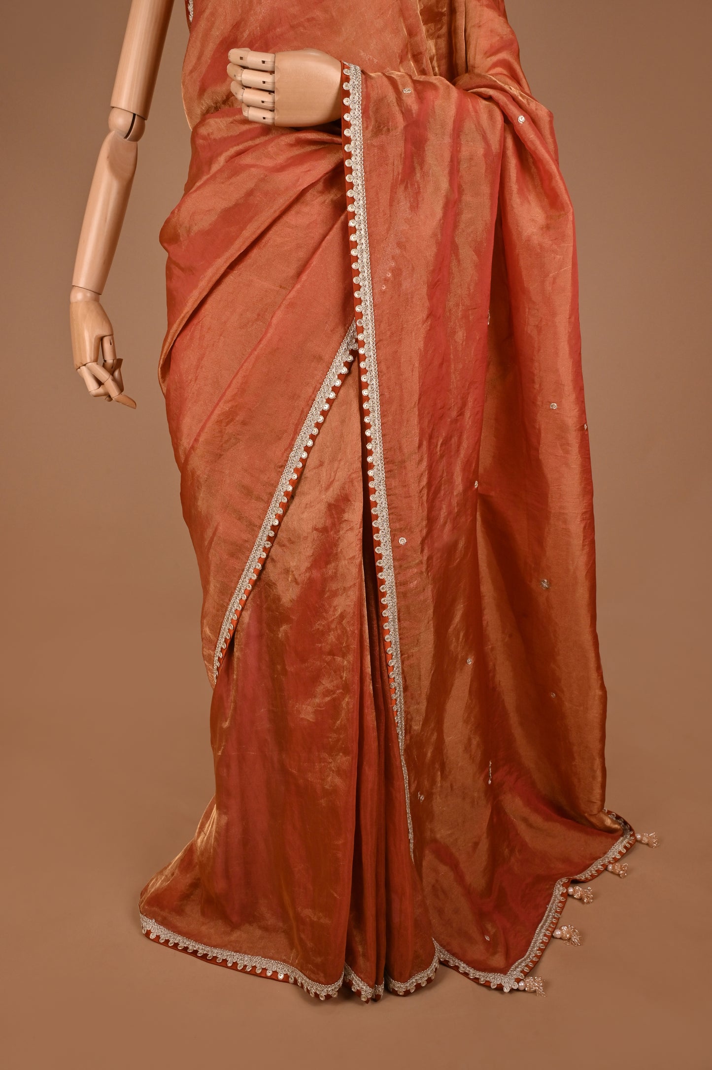 Earthy Rust Tissue Saree with Lace Border and Tassel Details