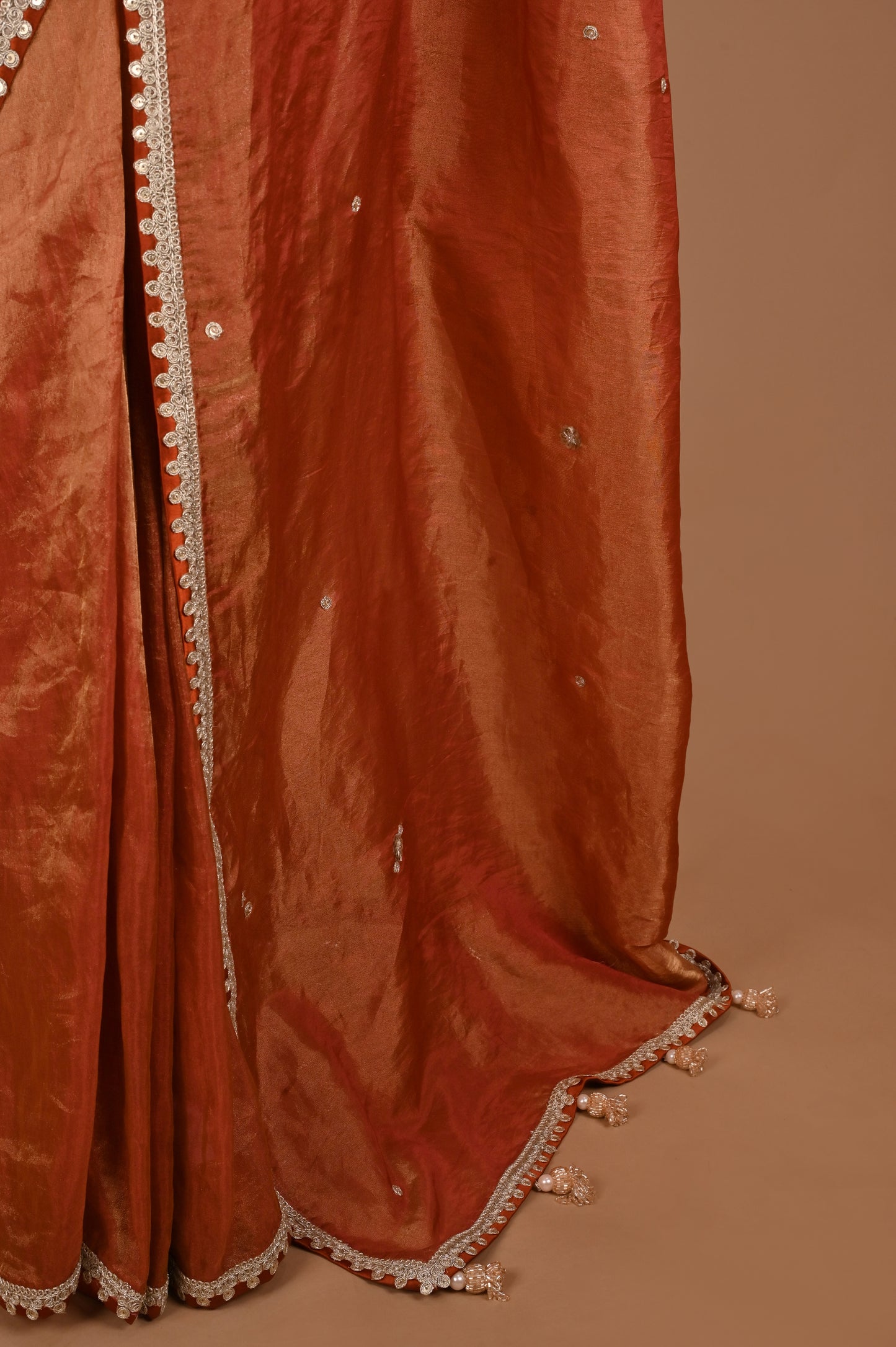 Earthy Rust Tissue Saree with Lace Border and Tassel Details