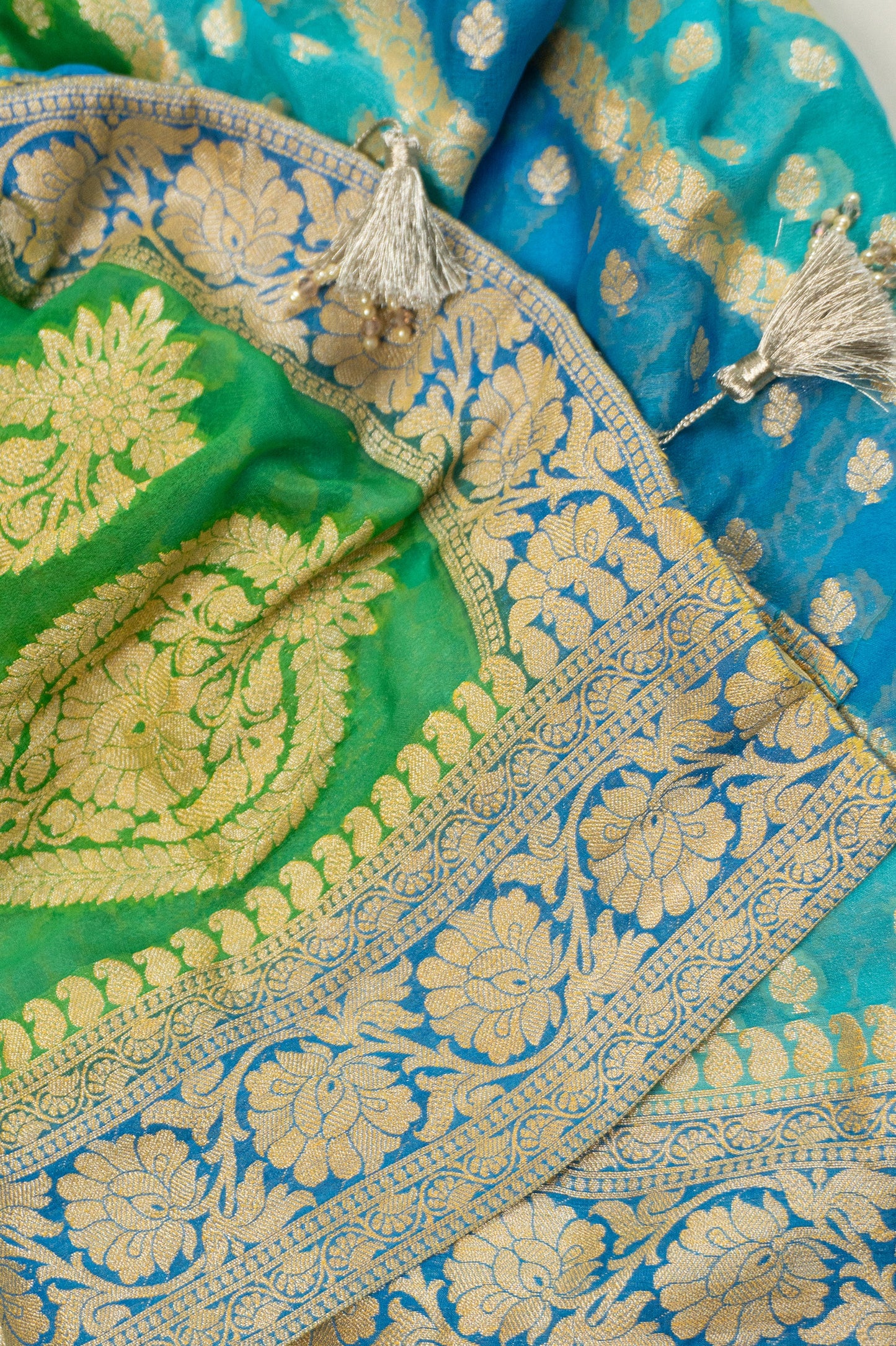 Multi-Colored Banarasi Silk Georgette Saree in Blue and Green with Gold Tissue Facing, Zari, and Pearl Tassels on Saree and Blouse