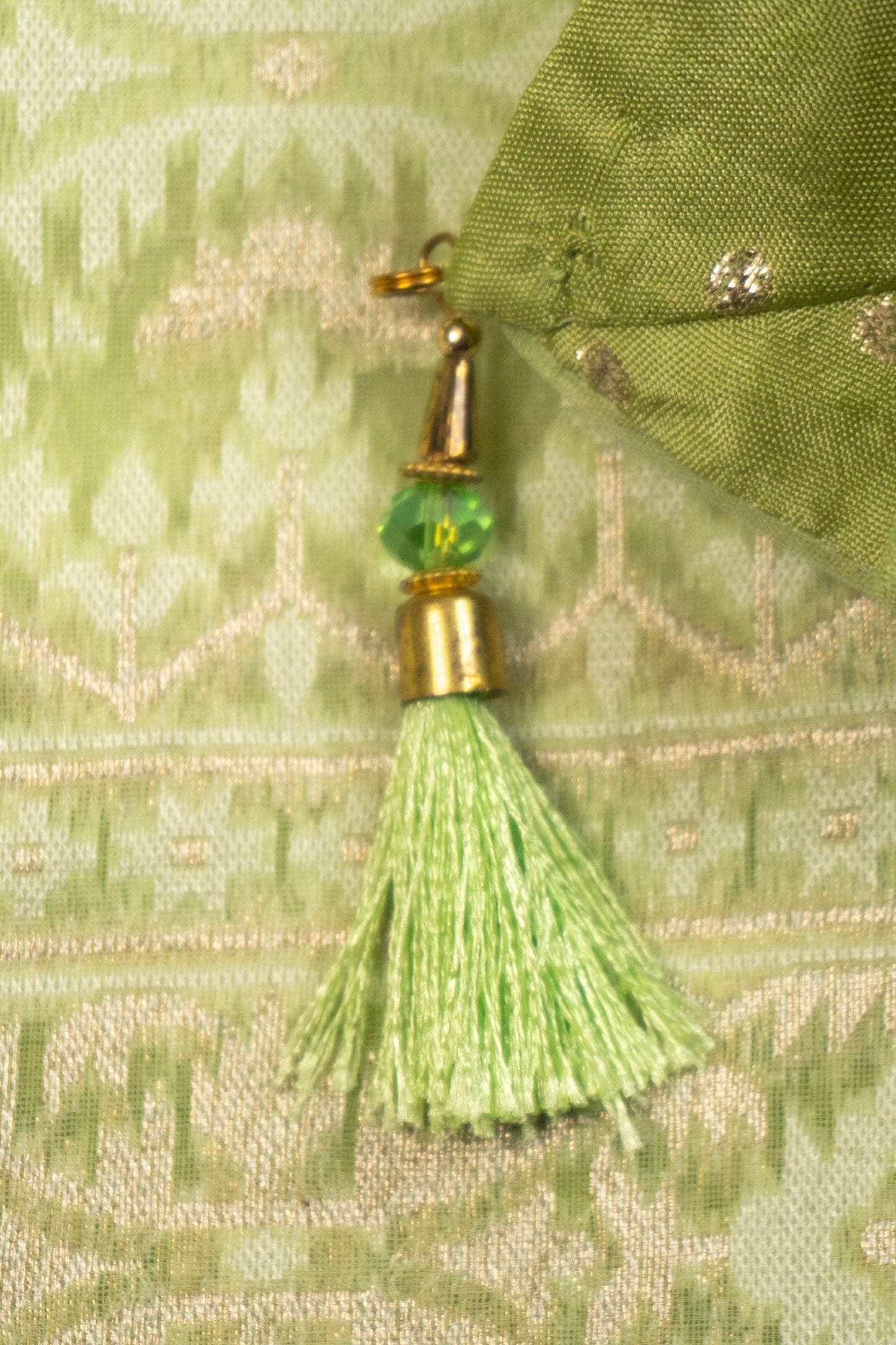 Pista Green Woven Organza Silk Saree with Intricate Diamond Pattern, Floral Border, Lurex Butta Facing, and Tassels on Saree and Blouse