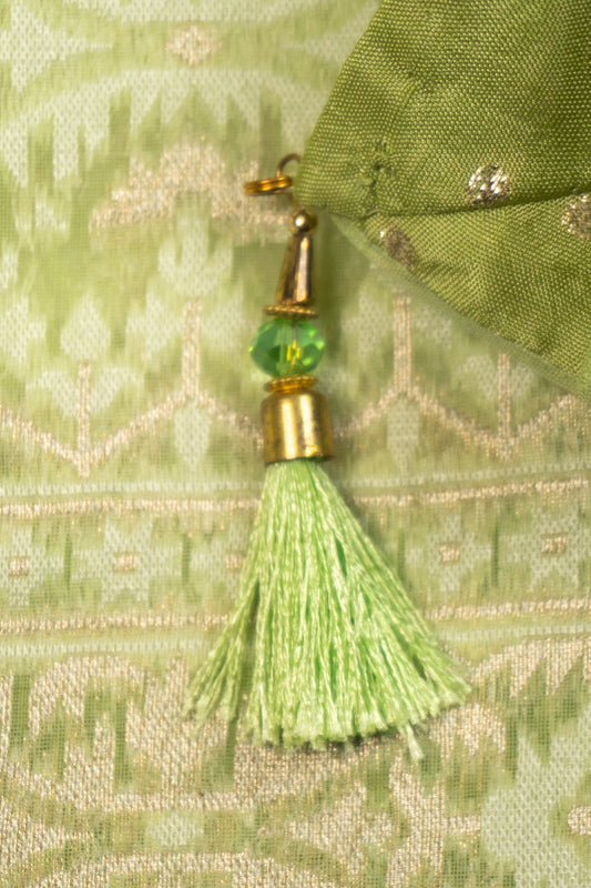 Pista Green Woven Organza Silk Saree with Intricate Diamond Pattern, Floral Border, Lurex Butta Facing, and Tassels on Saree and Blouse