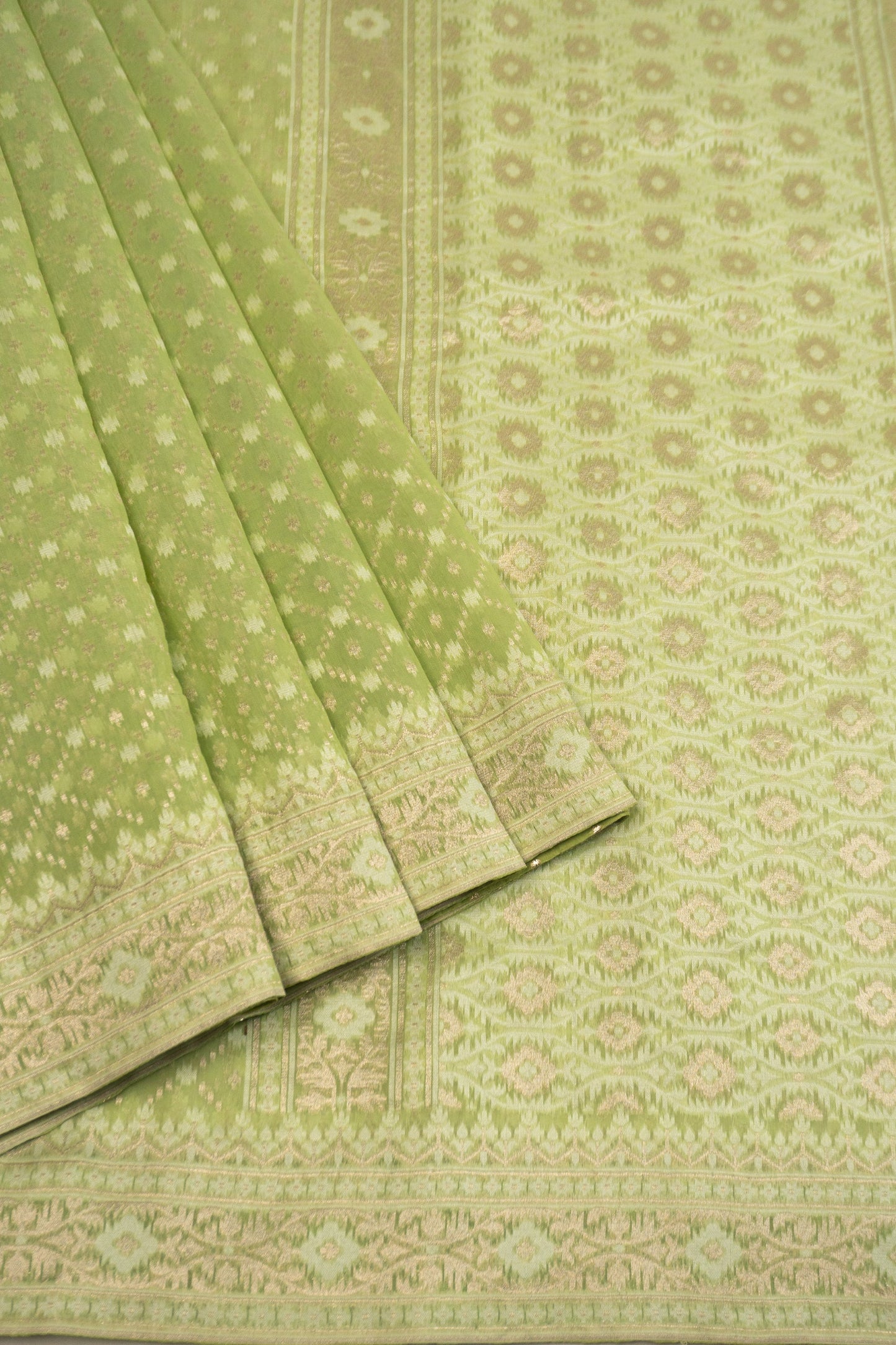 Pista Green Woven Organza Silk Saree with Intricate Diamond Pattern, Floral Border, Lurex Butta Facing, and Tassels on Saree and Blouse