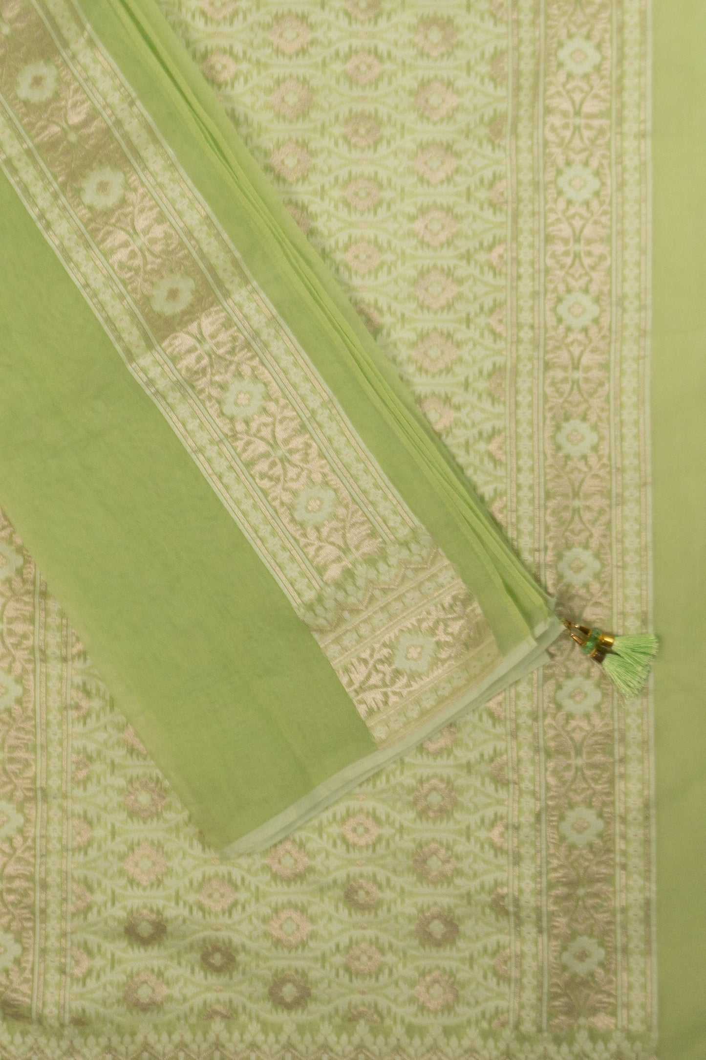 Pista Green Woven Organza Silk Saree with Intricate Diamond Pattern, Floral Border, Lurex Butta Facing, and Tassels on Saree and Blouse