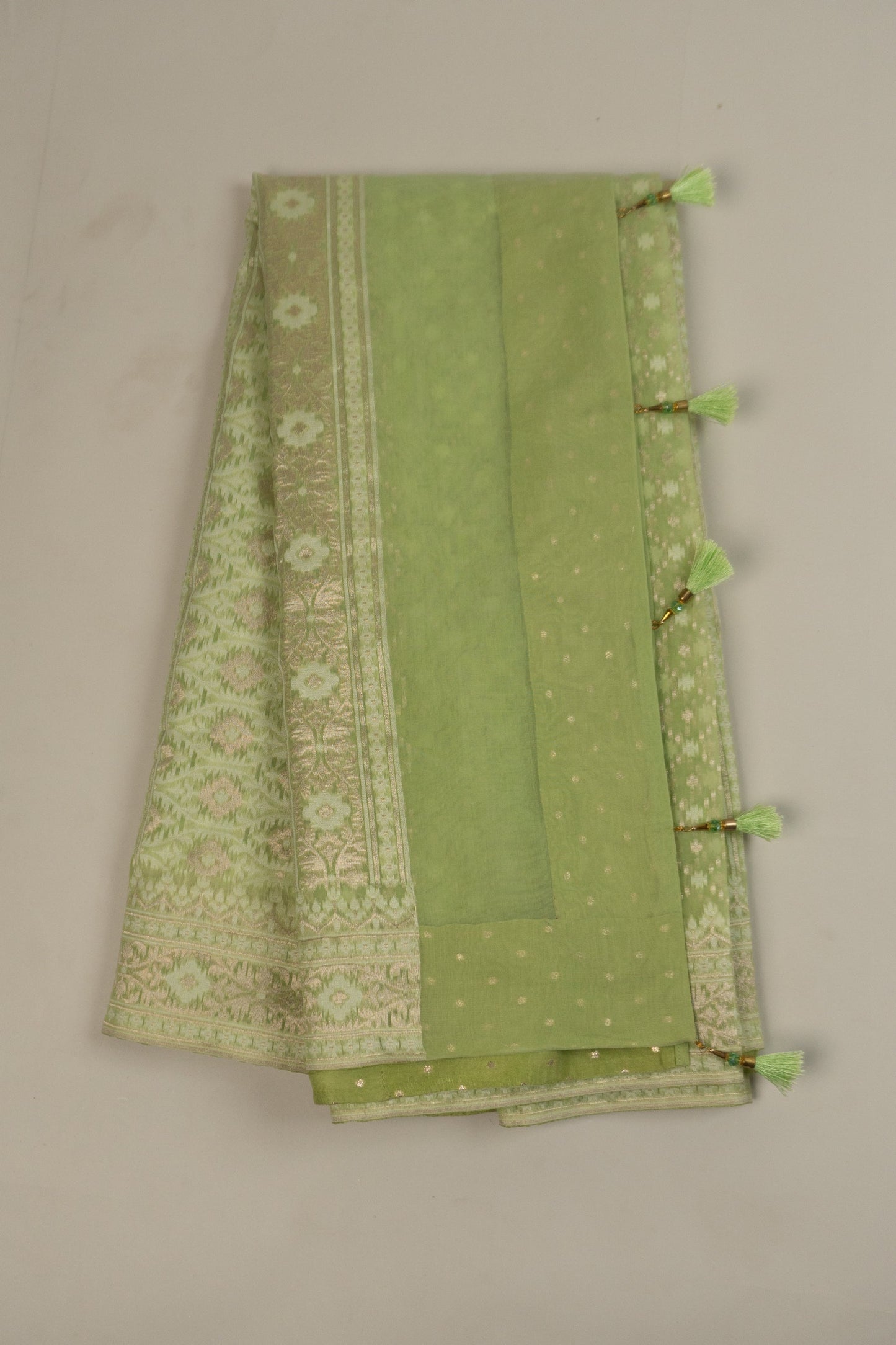 Pista Green Woven Organza Silk Saree with Intricate Diamond Pattern, Floral Border, Lurex Butta Facing, and Tassels on Saree and Blouse